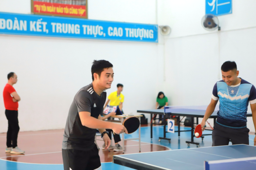 A group of people playing ping pong

Description automatically generated
