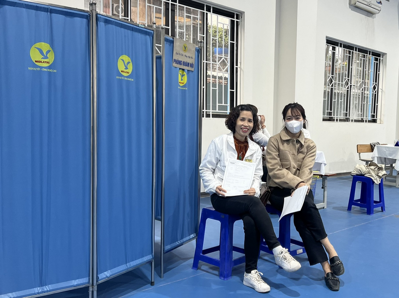A couple of women sitting on stools in a room with blue doors

Description automatically generated with low confidence