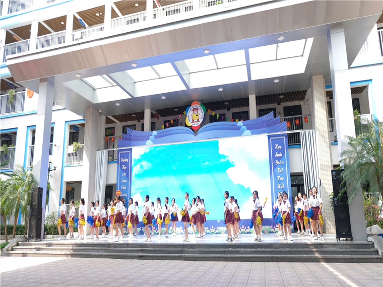 A group of people performing on stage

Description automatically generated