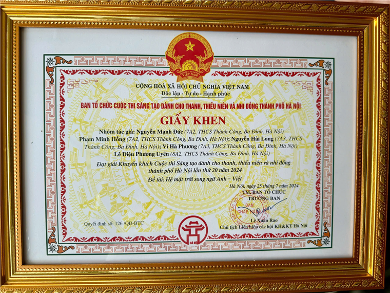 A certificate in a gold frame

Description automatically generated