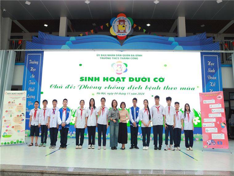 A group of people standing on a stage

Description automatically generated