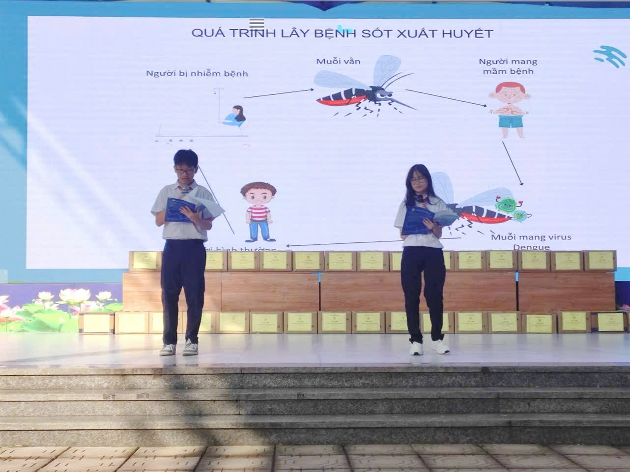 A person and person standing on a stage

AI-generated content may be incorrect.