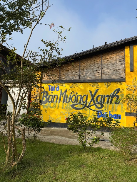A yellow building with black writing on it

Description automatically generated