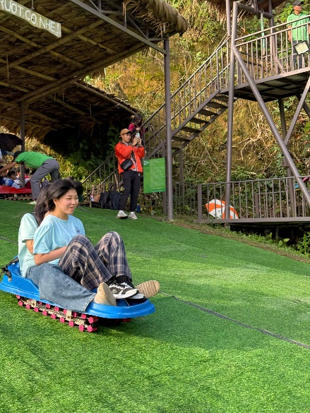 A person on a sled on a hill

Description automatically generated