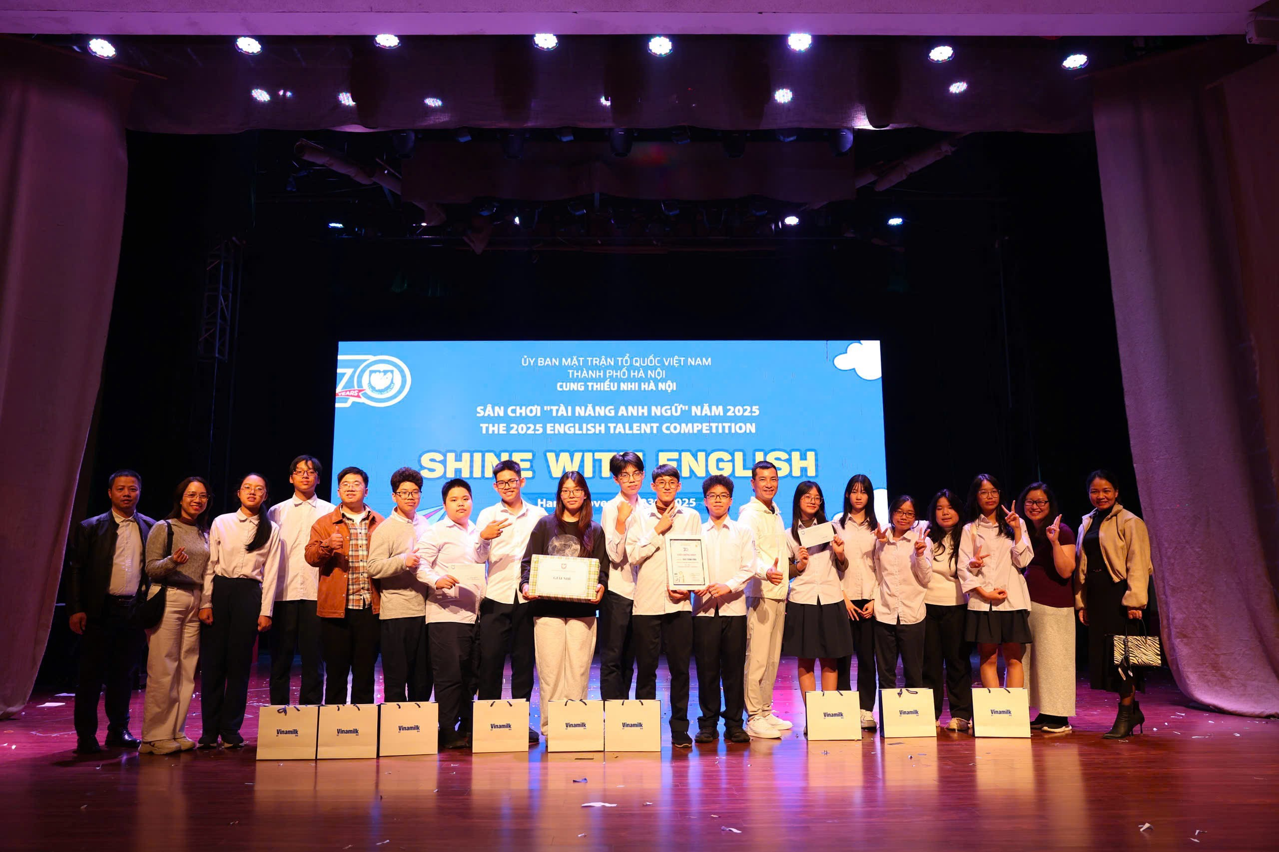 A group of people on a stage
Description automatically generated