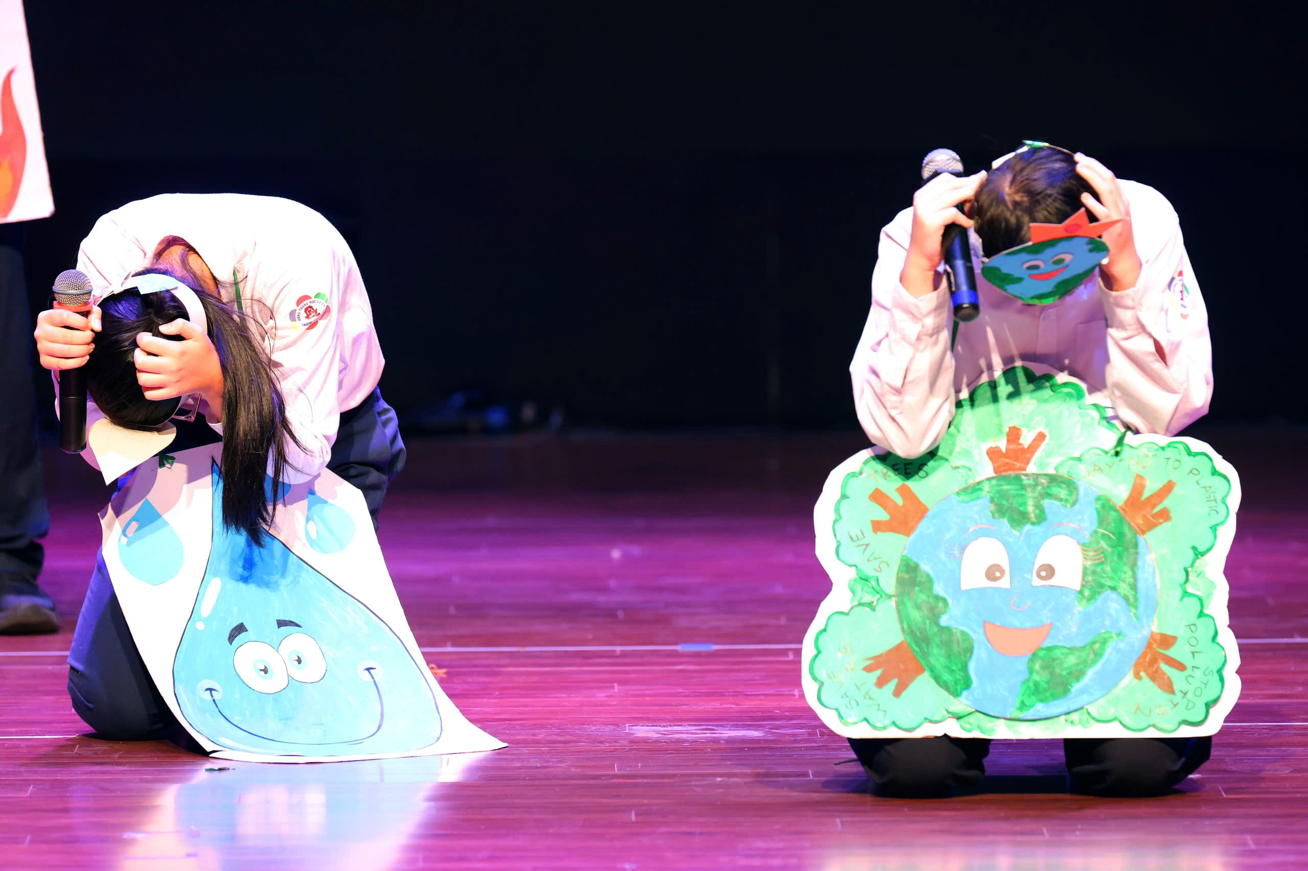 A person and person on stage with a microphone
Description automatically generated