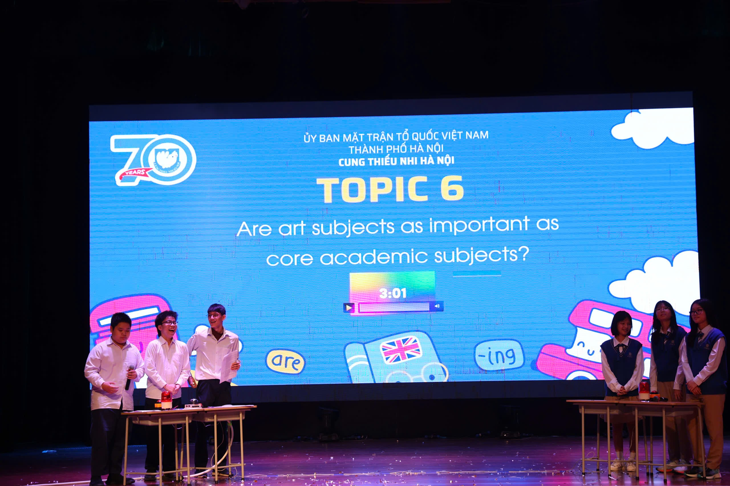 A group of people on a stage
Description automatically generated