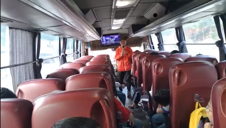 A person standing in a bus

AI-generated content may be incorrect.