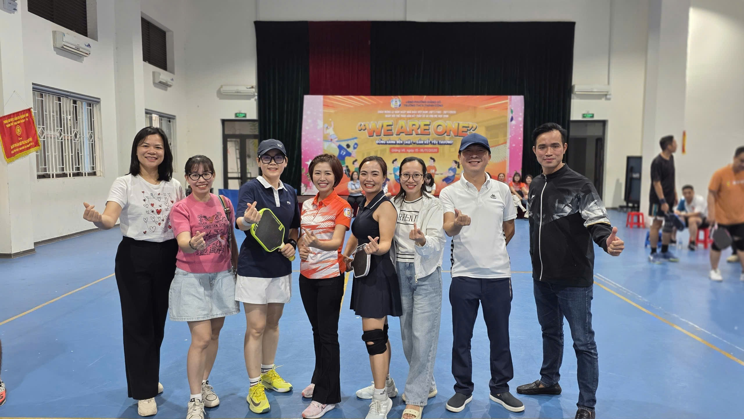 A group of people posing for a photo
Description automatically generated