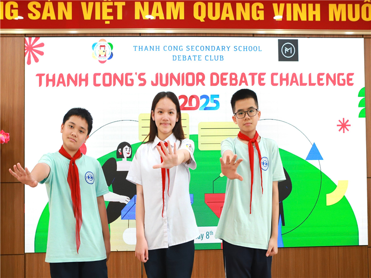 A group of people standing in front of a sign

Description automatically generated