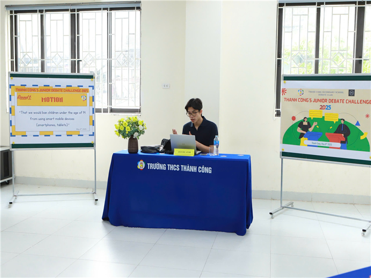 A person sitting at a table with a blue tablecloth

Description automatically generated