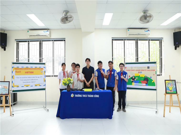A group of young men standing in front of a table

Description automatically generated