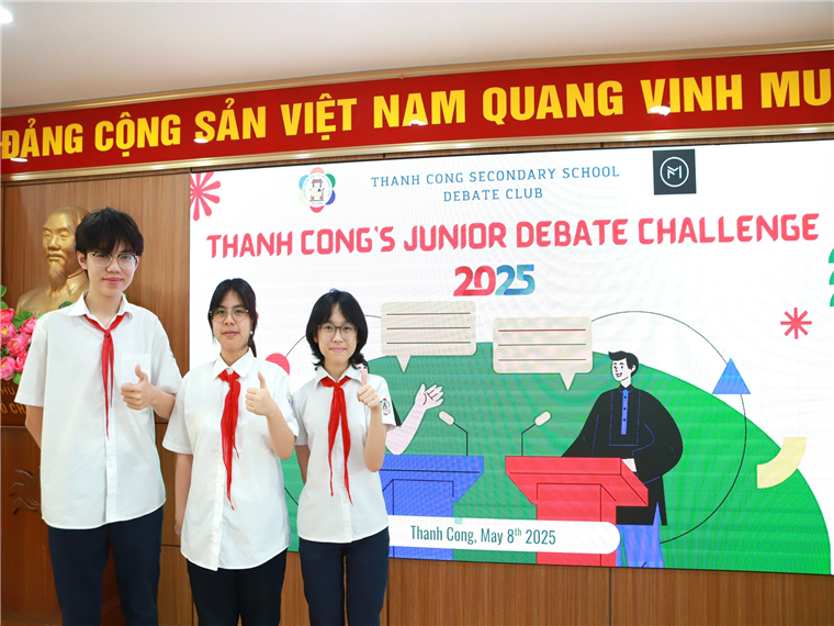 A group of people standing in front of a sign

Description automatically generated