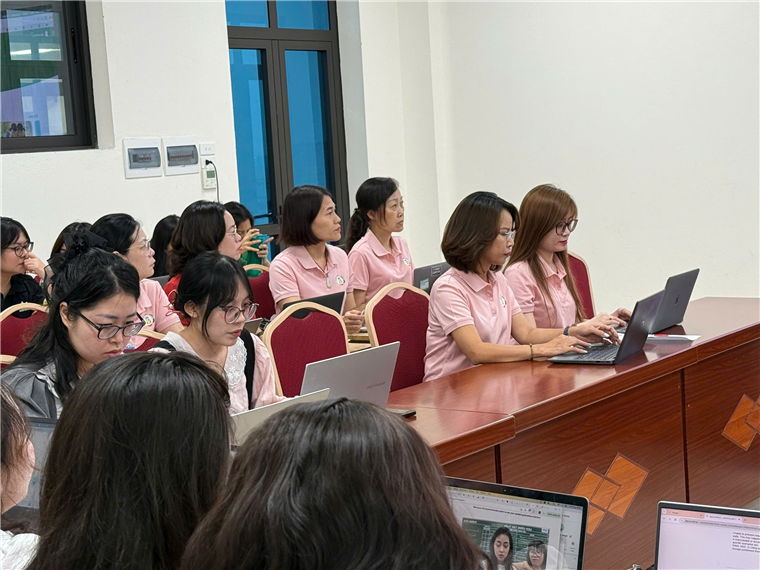 A group of women in pink shirts

Description automatically generated