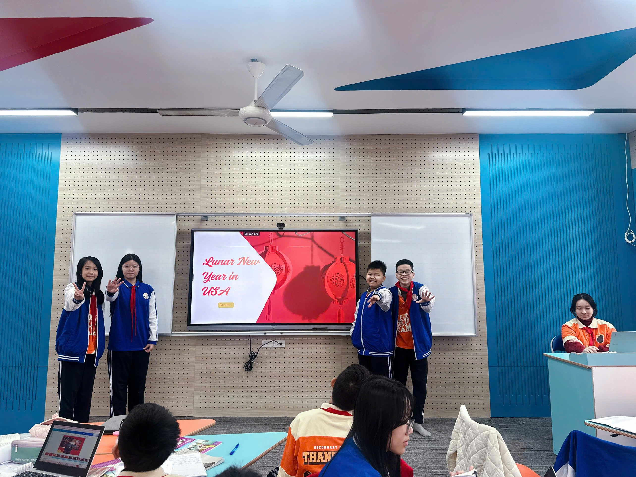 A group of people standing in a room

Description automatically generated