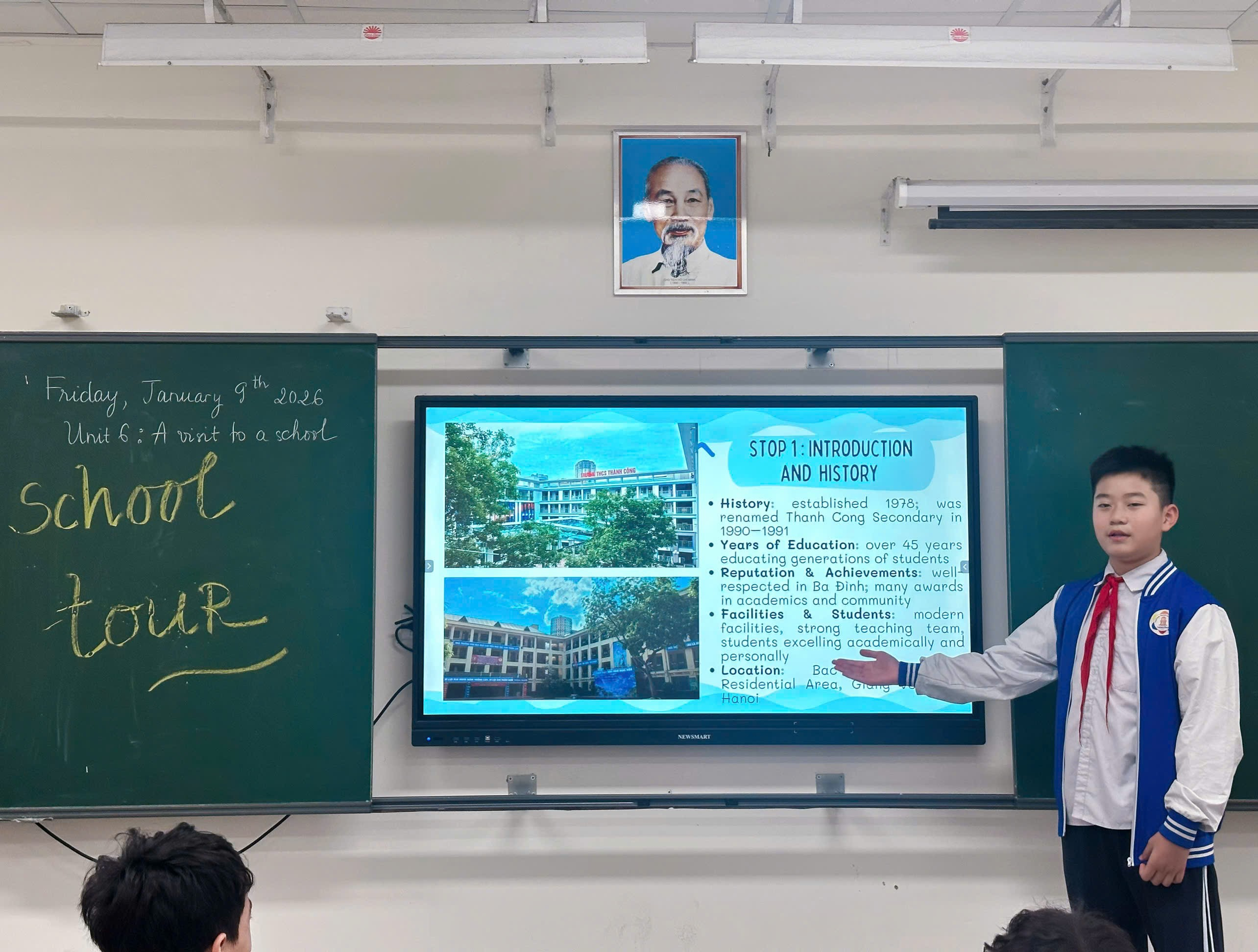 A person standing in front of a screen

Description automatically generated