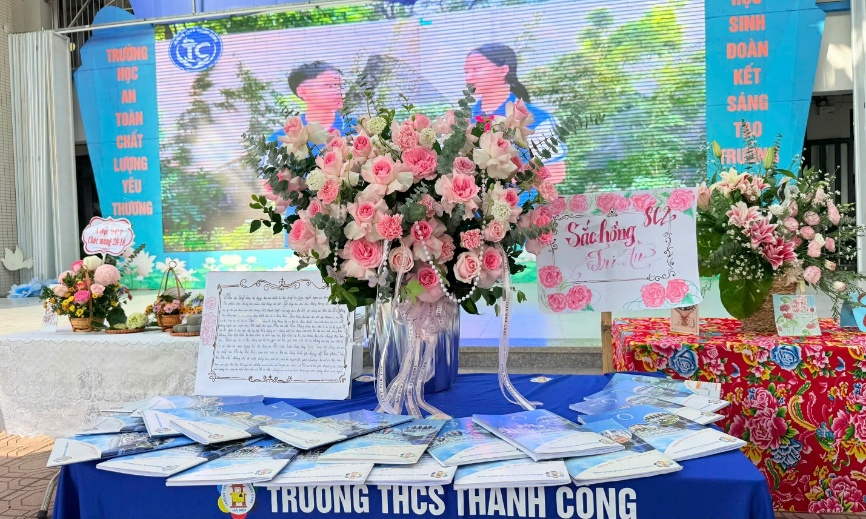 A table with flowers and signs

Description automatically generated