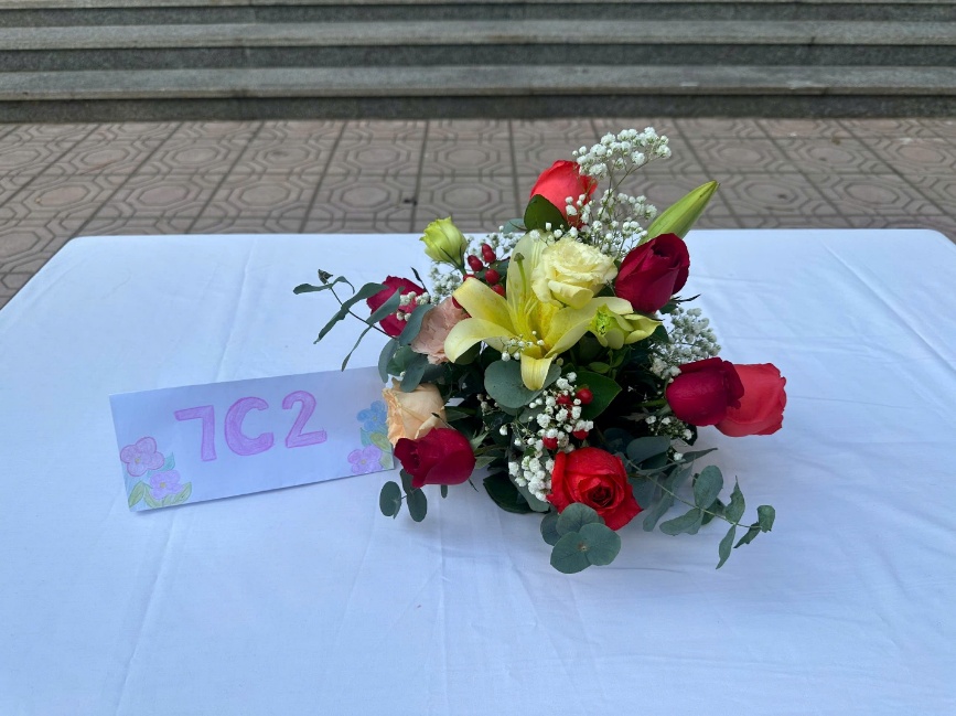A bouquet of flowers on a table
Description automatically generated