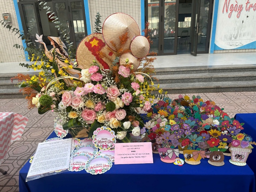 A table with flowers and signs on it
Description automatically generated