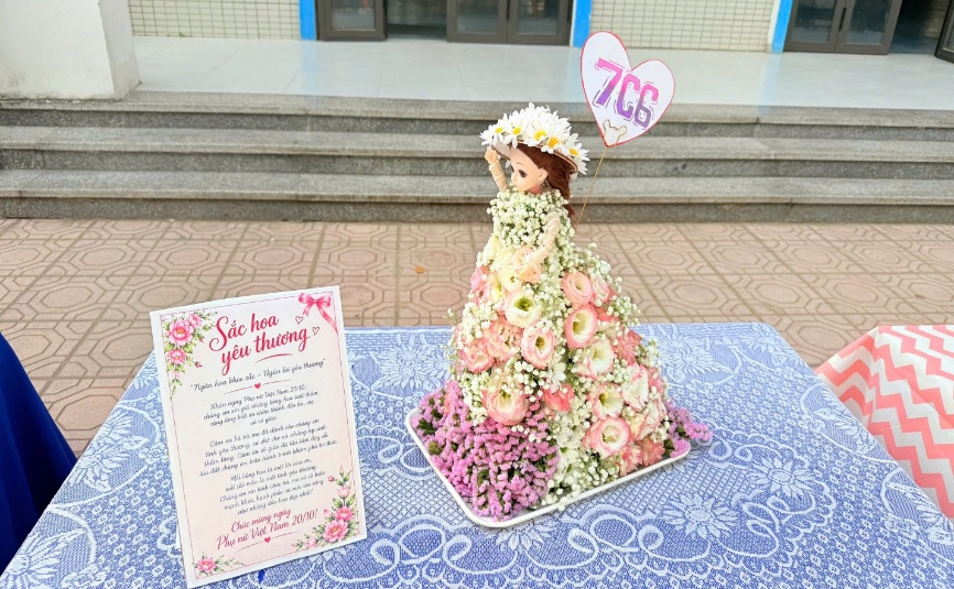 A statue of a person in a dress with flowers
Description automatically generated