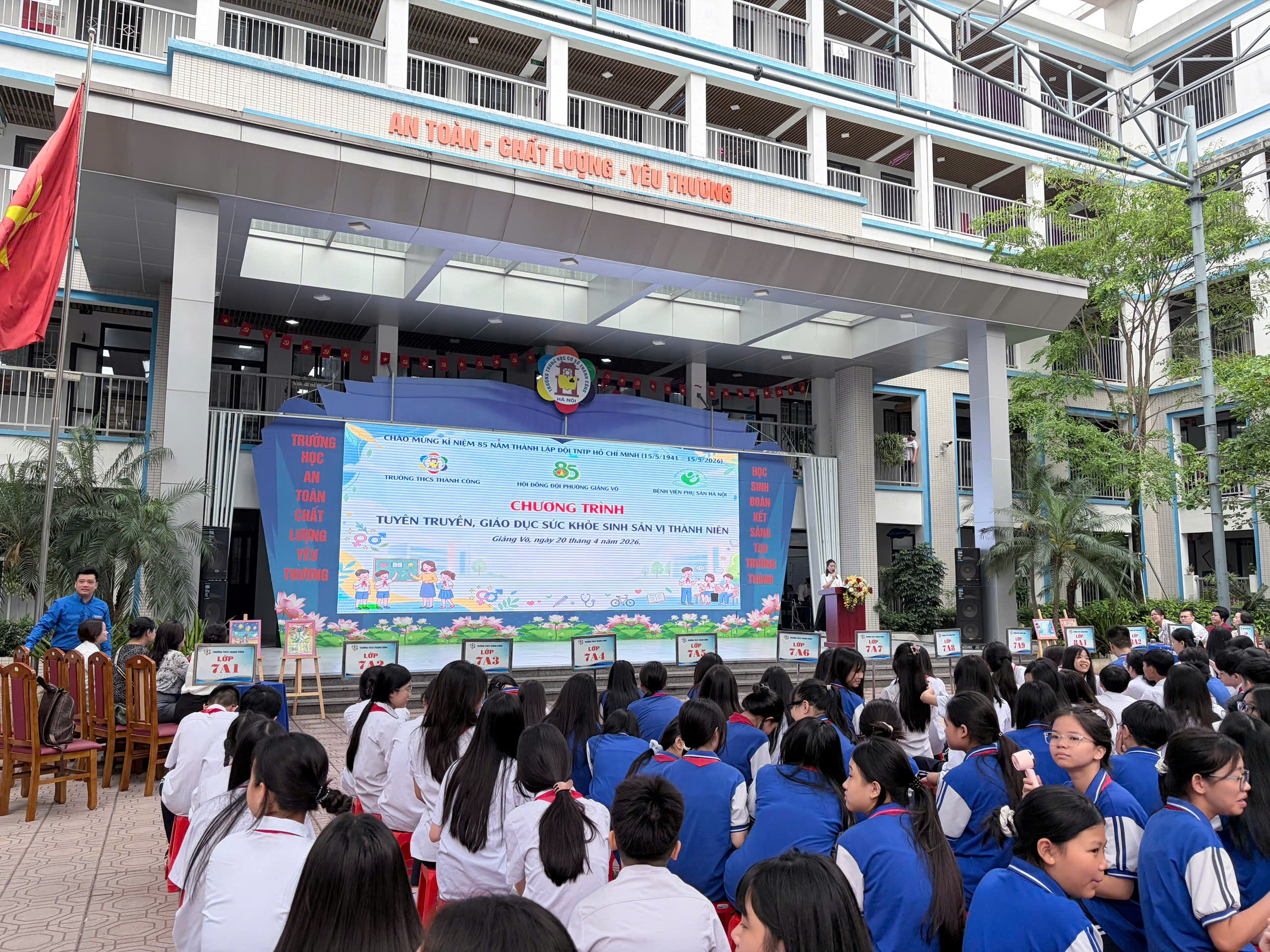 A group of children sitting in front of a building

AI-generated content may be incorrect.