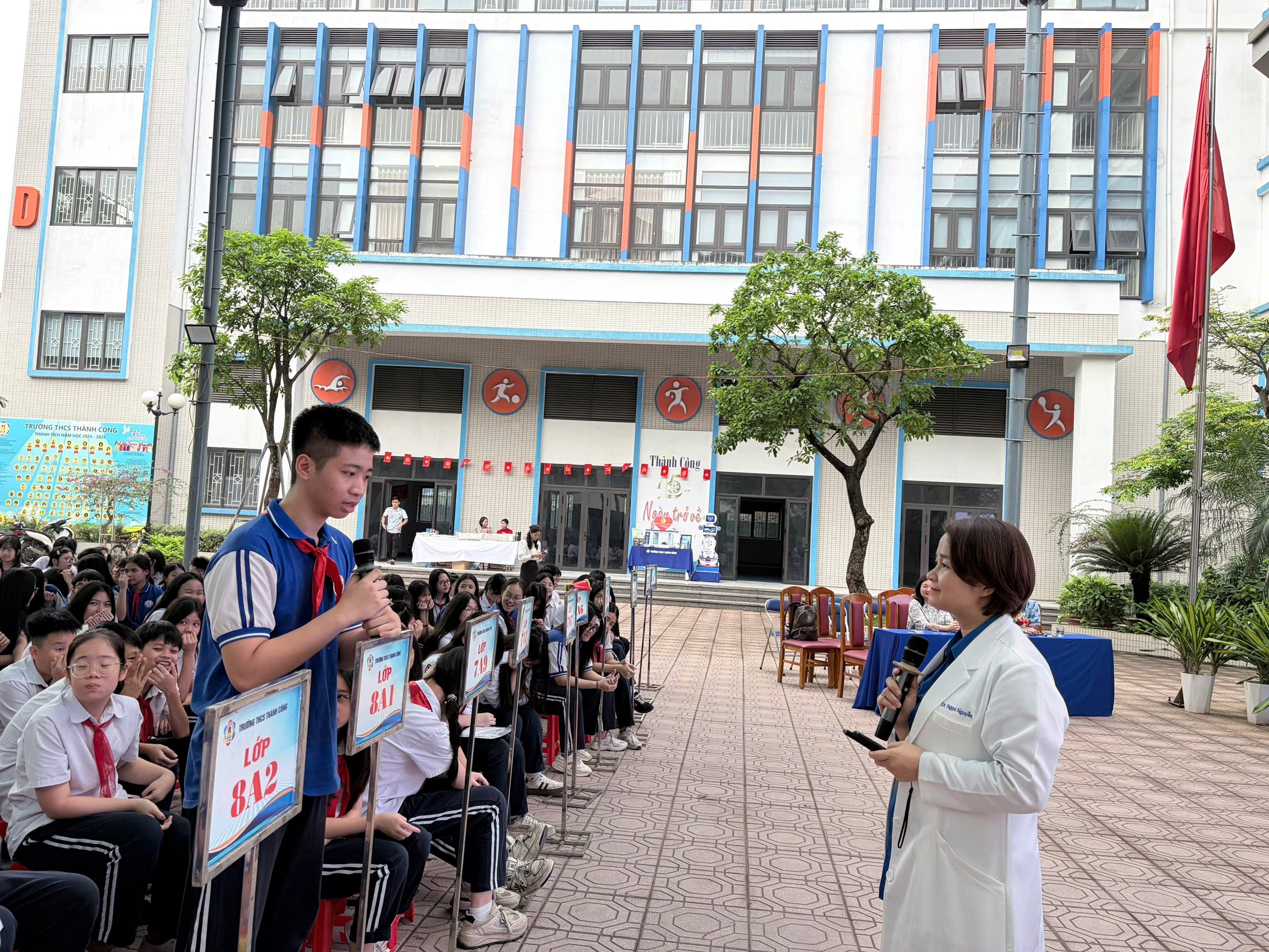 A person and person speaking into microphones in front of a group of people

AI-generated content may be incorrect.