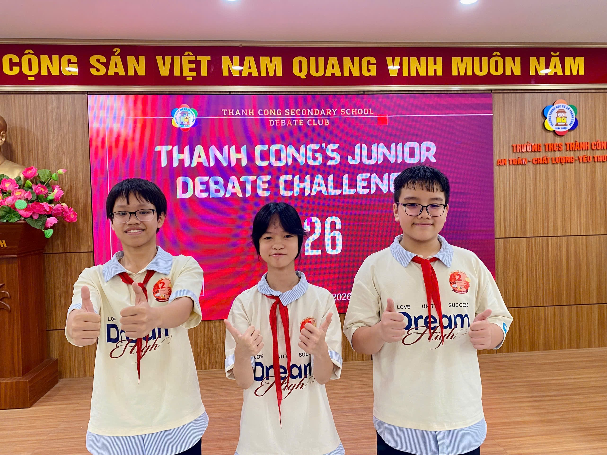 A group of boys in matching shirts giving thumbs up

Description automatically generated