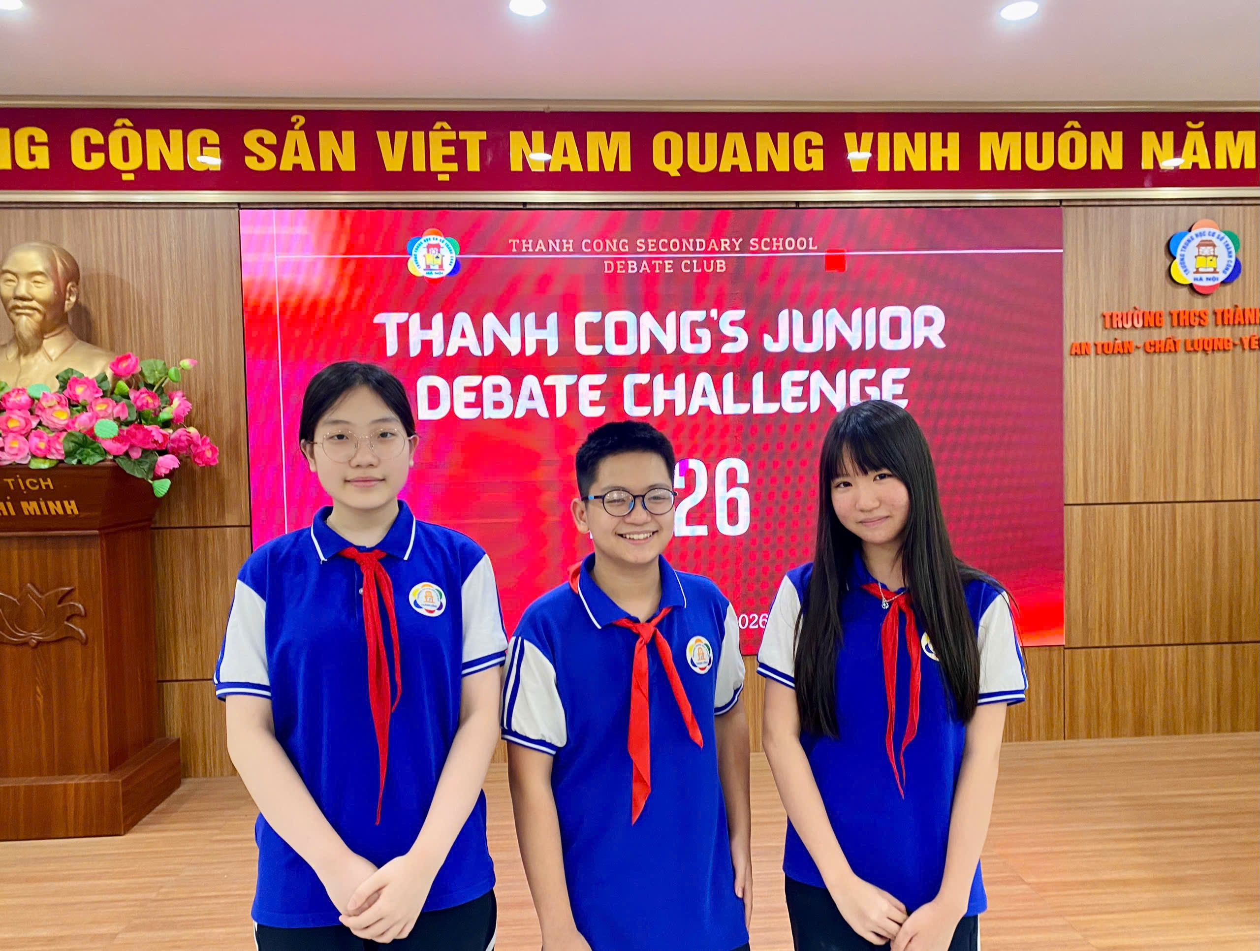 A group of people standing in front of a large sign

Description automatically generated